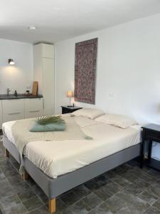a bedroom with a large white bed and a table at Finca Bona Nit in Jávea