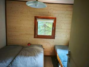 a small room with a bed and a window at Le Martagon - Proche Station de Ski in Gresse-en-Vercors