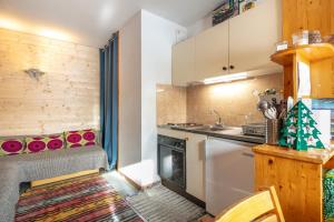 a small kitchen with a stove and a sink at Le Martagon - Proche Station de Ski in Gresse-en-Vercors