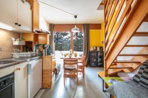 a kitchen with a staircase leading to a dining room at Le Martagon - Proche Station de Ski in Gresse-en-Vercors