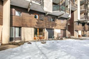 a apartment building with snow in front of it at Le Martagon - Proche Station de Ski in Gresse-en-Vercors