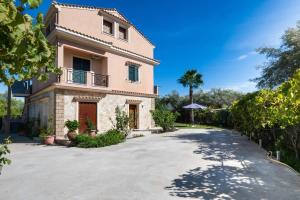 a large house with a driveway in front of it at Eleonora's Apartment in Lygia