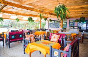 a restaurant with colorful tables and chairs and a table at Kijiji Beach Resort in Dar es Salaam