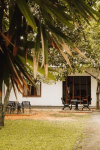 a group of benches in front of a building at Secret House in Dickwella