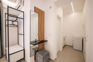 a dressing room with a mirror and a stool at Vila Amare in Sarandë
