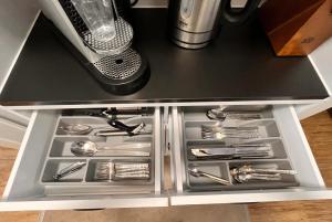 a drawer in a kitchen with silver utensils at Stilvolle 2 Zimmerwohnung in Fellbach