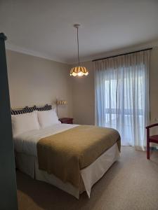 a bedroom with a large bed and a window at Villa Casa do Canal in Apúlia
