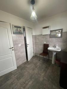 a bathroom with a sink and a toilet and a mirror at Casa Crăciun in Mănăstirea Humorului +34 photos