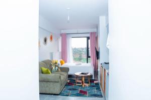 a living room with a couch and a bed at comfystdkiambu in Kiambu