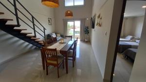 a dining room and living room with a table and chairs at Carcano Temporarios in Villa Carlos Paz +42 photos