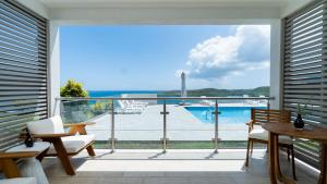 a balcony with a view of the ocean at Ruby - 2-bed condo with pool in Saint Georgeʼs