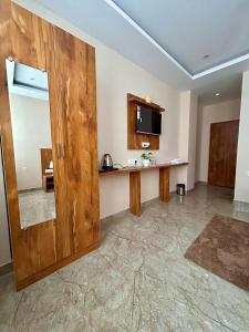 a kitchen with a wooden door and a counter at Namaste Hostel Rishikesh in Rishīkesh