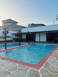 a large swimming pool in front of a building at Casa Yangu in Watamu