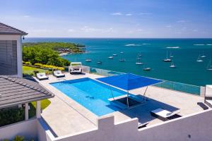 an aerial view of a swimming pool and the ocean at Ruby - 2-bed condo with pool in Saint Georgeʼs