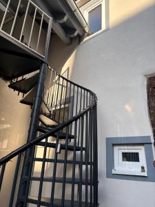 a spiral staircase next to a building with a window at Idyllisches Kleinod in Gerolzhofen