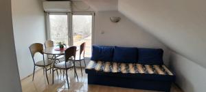 a living room with a couch and a table at Airport Guesthouse Rooms and Apartmants in Beograd