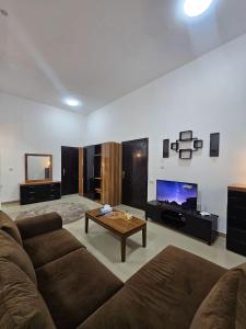 a living room with a couch and a coffee table at Big studio in Jimi Alain city in Al Ain