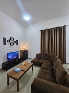 a living room with a couch and a coffee table at Big studio in Jimi Alain city in Al Ain