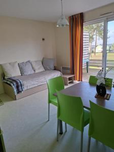 a bedroom with a bed and a table and chairs at cottage poussin 12 picine lave linge in Chaveignes