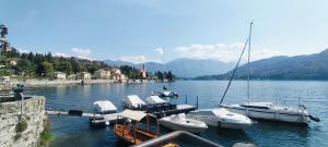 a group of boats docked at a dock on a lake at Casa Milla in Tremezzo
