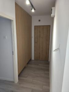 an empty hallway with a door and a wooden door at Apartament w Biłgoraju in Biłgoraj