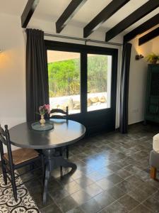 a dining room with a table and a window at Finca Bona Nit in Jávea