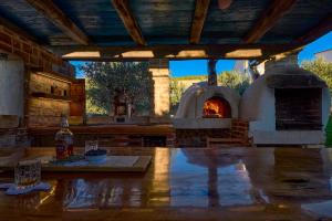 an outdoor kitchen with a pizza oven on a table at Villa Stone Lace in Kolan