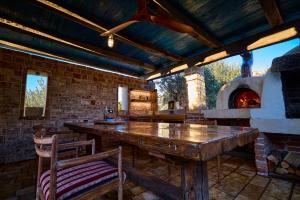 a room with a large wooden table and an oven at Villa Stone Lace in Kolan