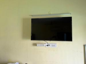 a flat screen tv hanging on a wall at The ARCS in Madurai