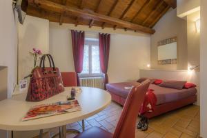 a bedroom with a table and a bed and a table and chair at Saffi 103 in Viterbo