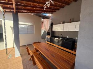a living room with a dining table and a kitchen at Casa com Piscina em Jarinu in Jarinu