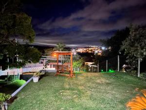 a playground in a yard at night at Casa com Piscina em Jarinu in Jarinu