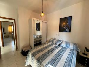 a bedroom with a bed in a room with a mirror at Casa com Piscina em Jarinu in Jarinu
