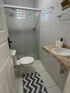 a bathroom with a shower and a toilet and a sink at Sweet home in São Luís