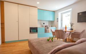 a kitchen with a bed and a table and chairs at Blue Bay Apartment Piran in Piran