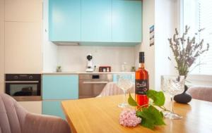 a bottle of wine and two wine glasses on a table at Blue Bay Apartment Piran in Piran +7 photos