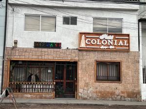 a colombian restaurant with a sign on the side of a building at Hostal Colonial in Iquique