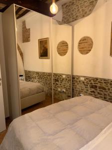 a bedroom with a bed and a mirror at Dimora dei cesari in Città di Castello