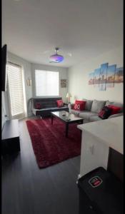a living room with a couch and a coffee table at The 513 Flat! 1BR, 1Bath Apt with Pool and Riverfront View! Free Gated Parking! Only Steps from The banks & Stadiums! in Cincinnati