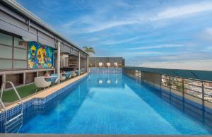 a swimming pool on the roof of a building at Radisson Hyderabad Hitec City in Hyderabad