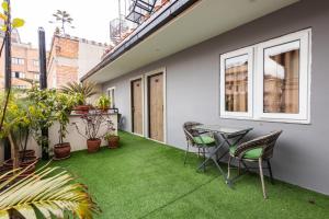a balcony with a table and chairs and plants at Divya Boutique Inn in Kathmandu