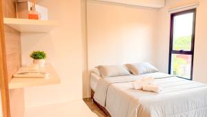 a white room with a bed and a window at Civis Jardinia Studio Close to Everything in Luque +19 photos