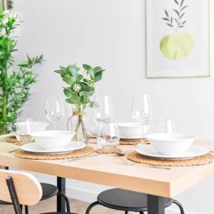 a dining room table with white plates and wine glasses at Stylish 3 Bedroom House - King Size Beds - 5 Guests - Garden & Parking 4VC in Minworth