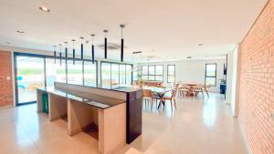 a kitchen with a counter and a dining room at Civis Jardinia Studio Close to Everything in Luque
