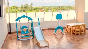 a balcony with two play equipment and a table at Civis Jardinia Studio Close to Everything in Luque