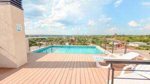 a swimming pool on top of a wooden deck at Civis Jardinia Studio Close to Everything in Luque