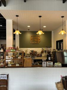 a fast food restaurant with a counter and lights at Febb x Vintage Room in Ban Ko Takhian
