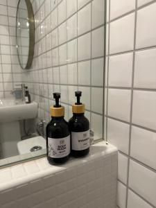 two bottles sitting on a counter in a bathroom at Febb x Vintage Room in Ban Ko Takhian +36 photos