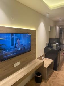 a room with a large flat screen tv on a wall at The Sterling Aroma in Greater Noida