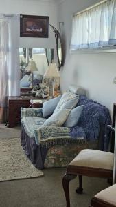 a bedroom with a bed with pillows and a mirror at Ahvenbloem Park in Kelso
